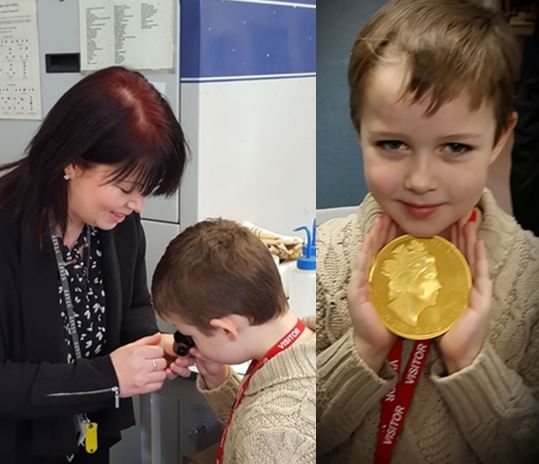 Julie Bull with her son James and James holding the gold commemorative coin
