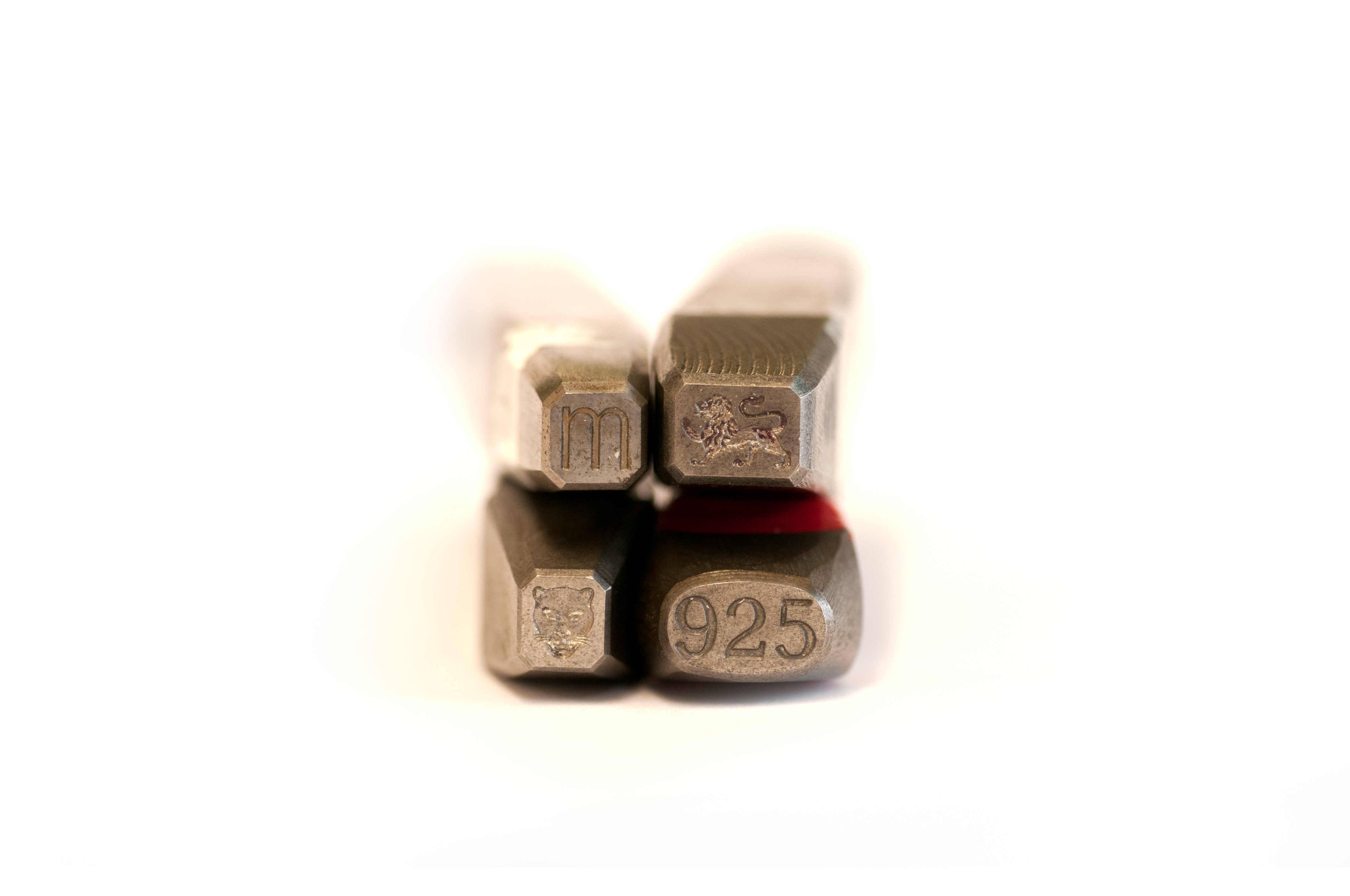 Punches, clockwise from top right, lion passant (traditional fineness symbol), millesimal fineness mark (925 indicating Sterling silver), leopard's head town mark, date letter.