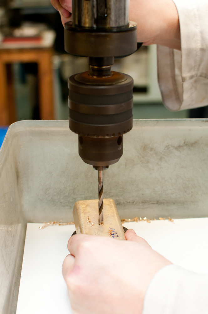 Drilling gold bar to test samples