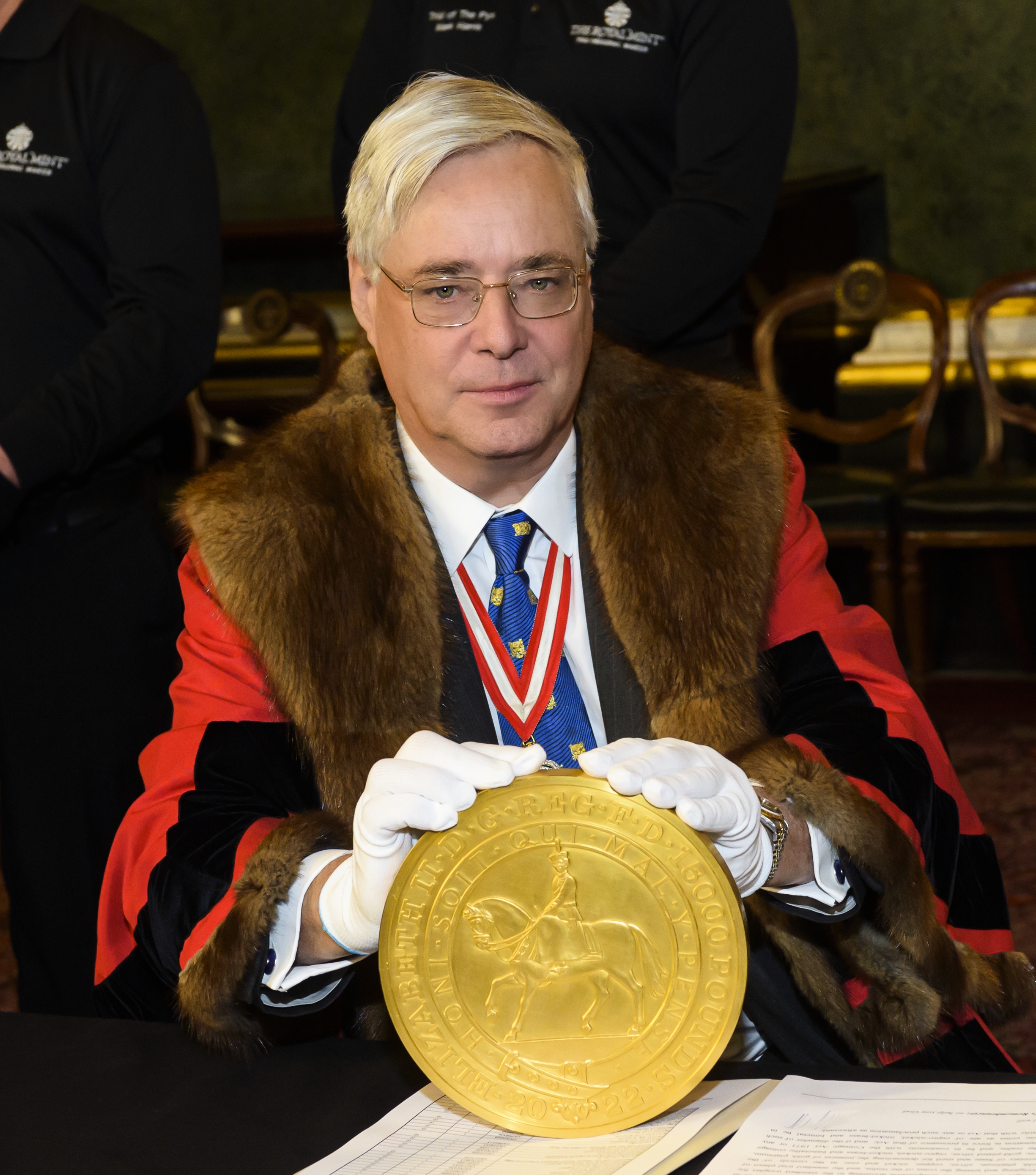 Pictured above is The Goldsmiths' Company Prime Warden, the Lord Bridges, holding the largest coin ever made by The Royal Mint. This 15kg masterpiece was created in celebration of Her Late Majesty The Queen’s Platinum Jubilee.